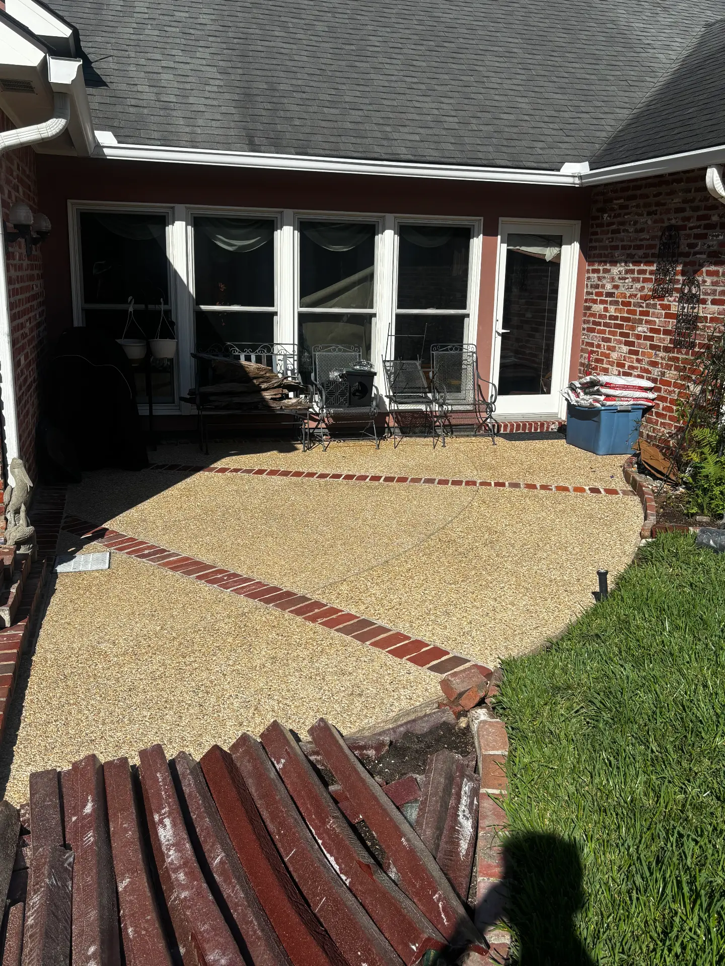 Patio with exposed aggregate concrete and brick borders after cleaning