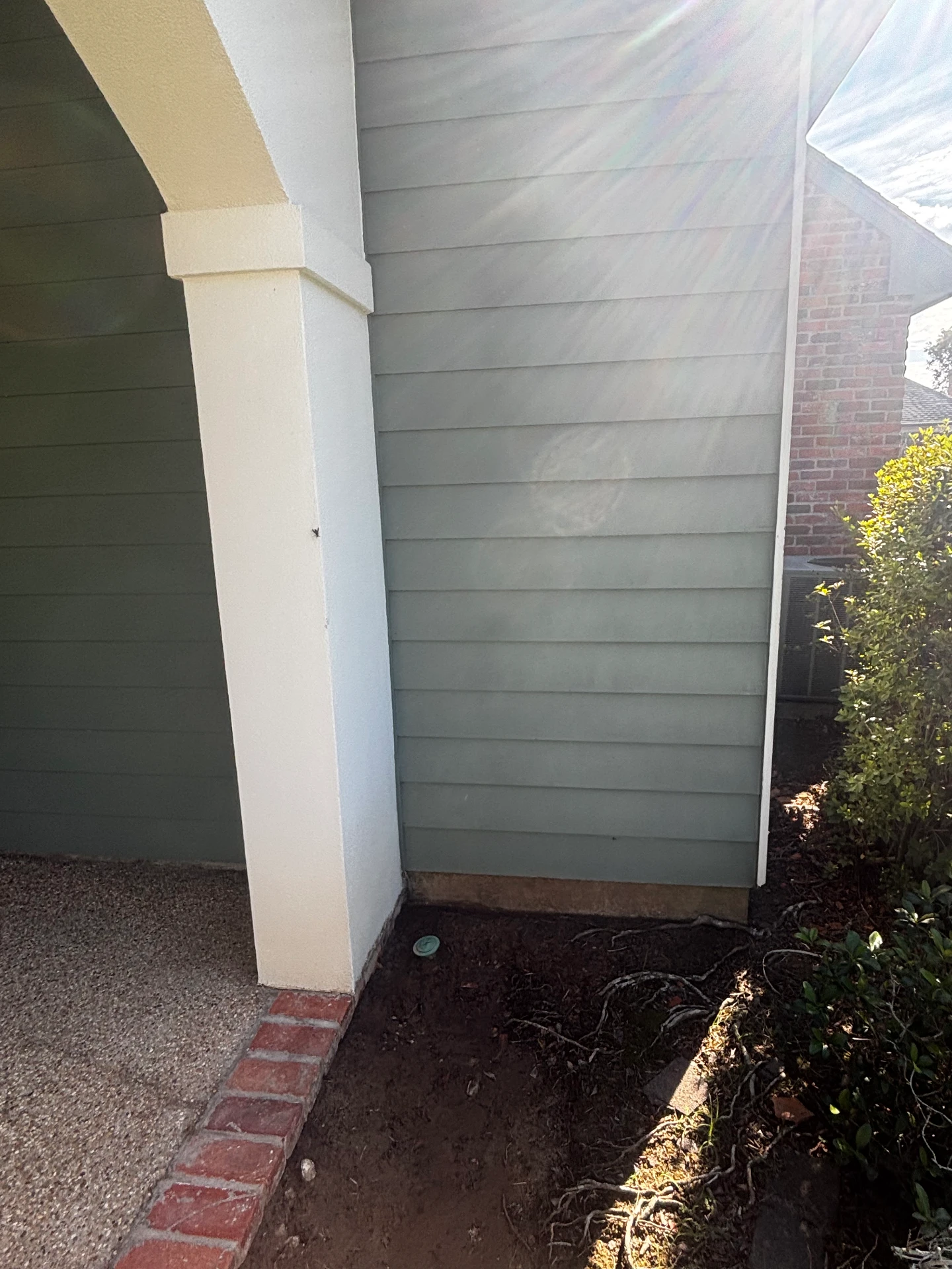 House siding beside the brick wall after cleaning